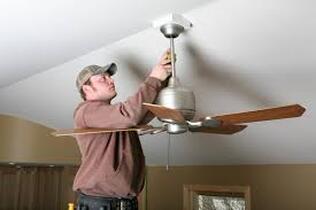 Man repairing ceiling fan