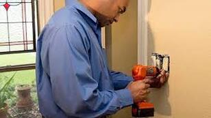 Man fixing light switch